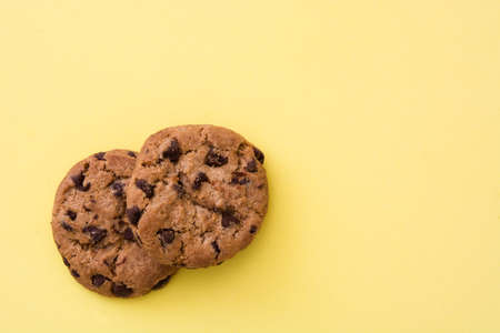 Chocolate chip cookies on yellow backgroundの写真素材