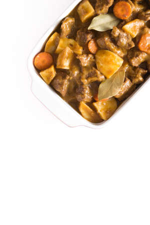 Beef stewed with potatoes, carrots and spices in ceramic pot isolated on white background.Top viewの写真素材