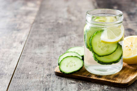 Detox water with cucumber and lemon on wooden tableの写真素材