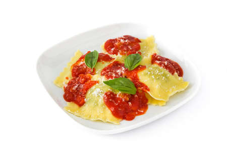 Ravioli with tomato sauce and basil isolated on white backgroundの写真素材