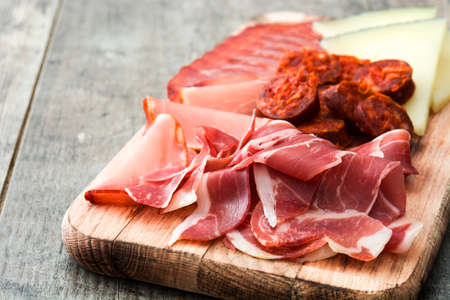 Spanish. Cheese, sausage and ham on wooden table