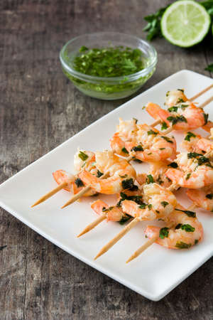 Shrimp skewers on wooden tableの写真素材