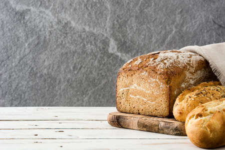 Mixed bread on white wooden table