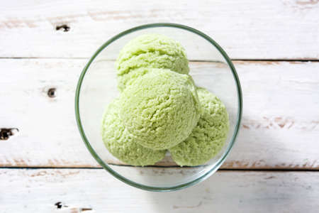 Green tea matcha ice cream on white wooden tableの写真素材