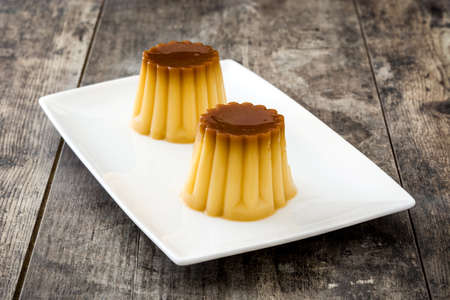 Caramel cream. Egg pudding on wooden table.の写真素材