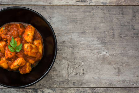 Chicken tikka masala in bowl on wooden tableの写真素材