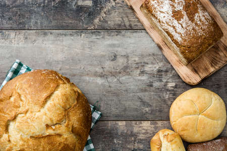 Mixed breads on wooden table.Top viewの写真素材
