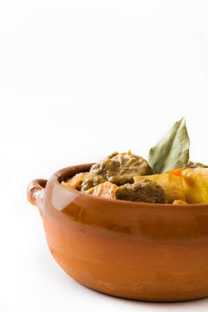 Beef stewed with potatoes, carrots and spices in ceramic bowl isolated on white backgroundの写真素材