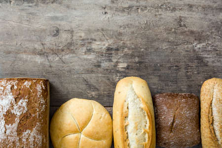 Mixed bread on wooden table. Top view