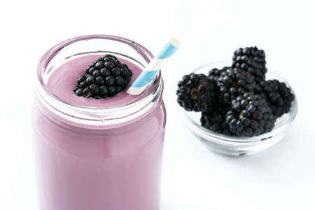 Healthy blackberry smoothie in glass isolated on white backgroundの写真素材