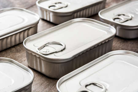 Cans of preserves on wooden tableの写真素材