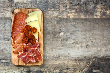 Spanish. Cheese, sausage and ham on wooden tableの写真素材