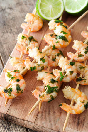 Shrimp skewers on wooden tableの写真素材