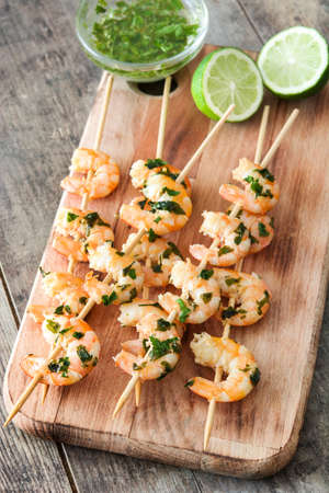 Shrimp skewers on wooden tableの写真素材