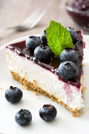 Piece of blueberry cheesecake on wooden tableの写真素材