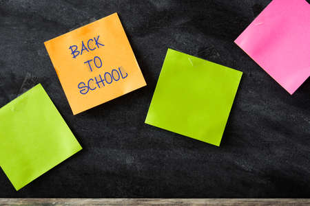 Colorful stick notes on blackboard background. Copyspace.の写真素材