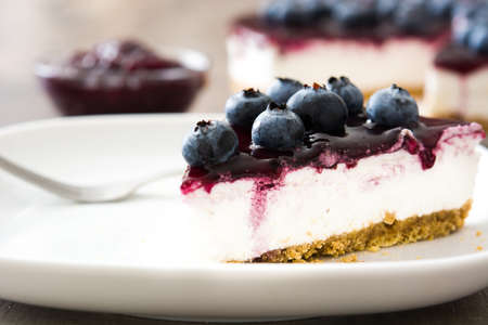 Piece of blueberry cheesecake on wooden tableの写真素材