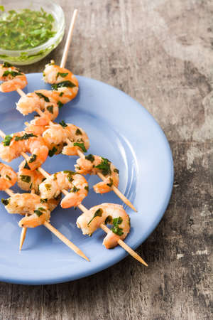Shrimp skewers on wooden tableの写真素材