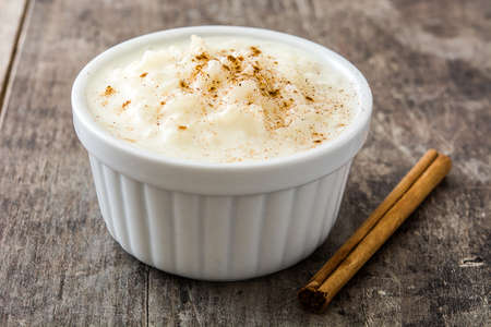 Rice pudding. Rice pudding with cinnamon on wooden backgroundの写真素材