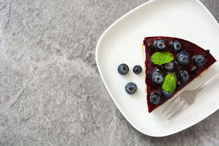 Piece of blueberry cheesecake on gray stoneの写真素材