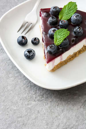 Piece of blueberry cheesecake on gray stoneの写真素材