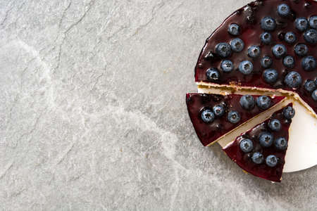 Piece of blueberry cheesecake on gray stoneの写真素材