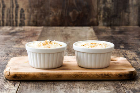 Rice pudding. Rice pudding with cinnamon on wooden backgroundの写真素材