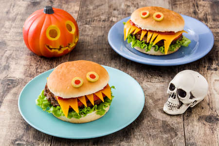 Halloween burger monsters on wooden tableの写真素材
