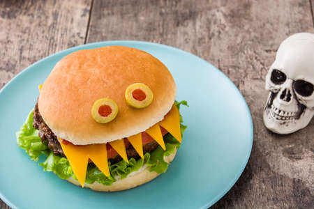 Halloween burger monsters on wooden tableの写真素材