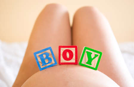 Pregnant woman with boy on belly wordの写真素材