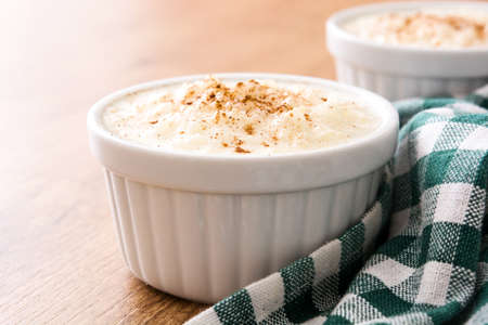 Rice pudding. Rice pudding with cinnamon on wooden backgroundの写真素材