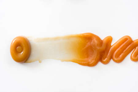 Toffee caramel candy and caramel sauce isolated on white background. Copyspace.の写真素材