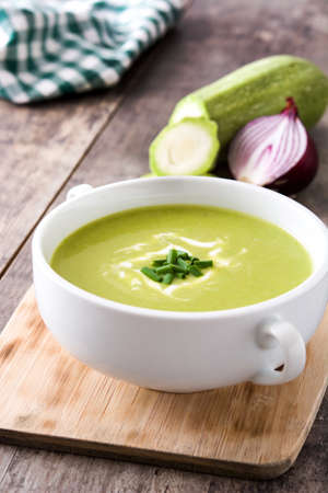 zucchini soup in bowl on wooden tableの写真素材