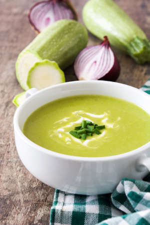 zucchini soup in bowl on wooden tableの写真素材