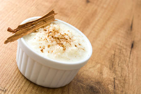 Rice pudding. Rice pudding with cinnamon on wooden backgroundの写真素材