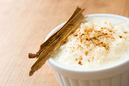 Rice pudding. Rice pudding with cinnamon on wooden backgroundの写真素材
