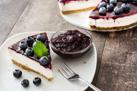 Piece of blueberry cheesecake on wooden tableの写真素材