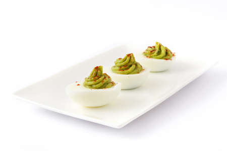 Stuffed eggs with guacamole isolated on white backgroundの写真素材