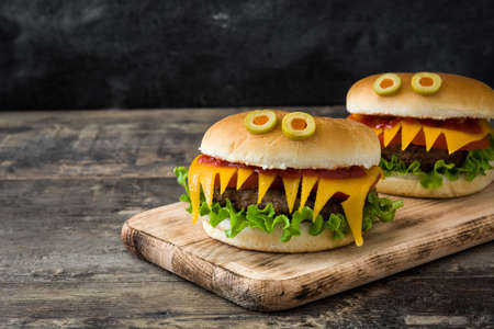 Halloween burger monsters on wooden table.Copyspaceの写真素材