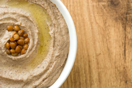 Lentil hummus in bowl on woodの写真素材