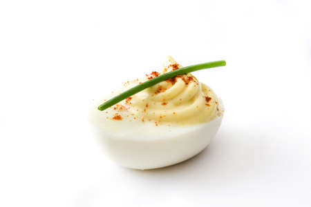Stuffed eggs with mustard, mayo and paprika isolated on white background