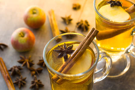Close up mulled cider in glass on wooden tableの写真素材
