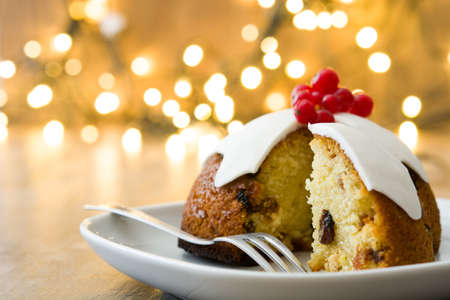 Christmas pudding and christmas light on wooden tableの写真素材