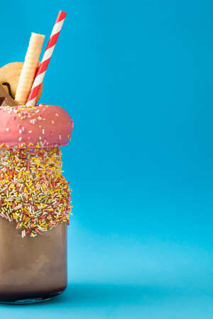 Extreme milkshake or freak shake on blue background.Copyspaceの写真素材