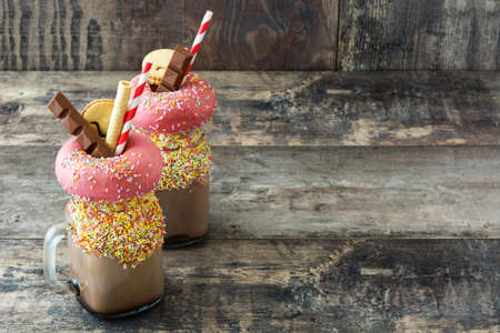 Extreme milkshake or freak shake on wooden table. Copyspaceの写真素材
