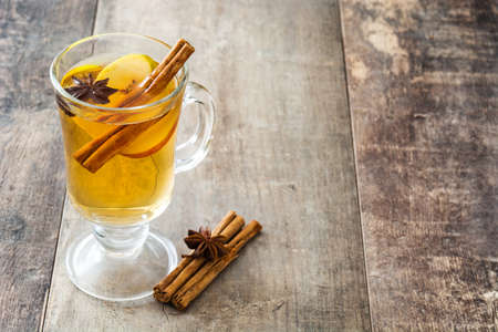 Mulled cider in glass on wooden table. Christmas drinkの写真素材