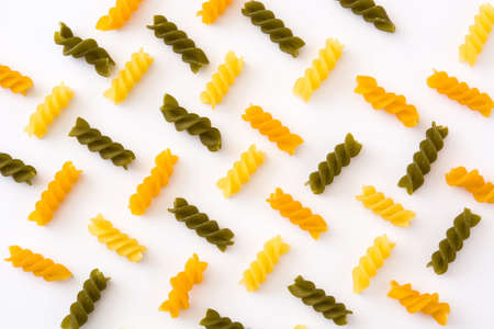 Colored pasta pattern on white background. Top view