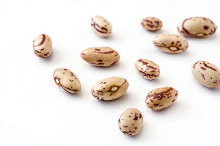 Raw pinto beans isolated on white background