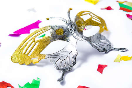 Carnival mask and colorful confetti on white background.の写真素材