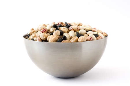 Uncooked assorted legumes in metal bowl isolated on white background.の写真素材